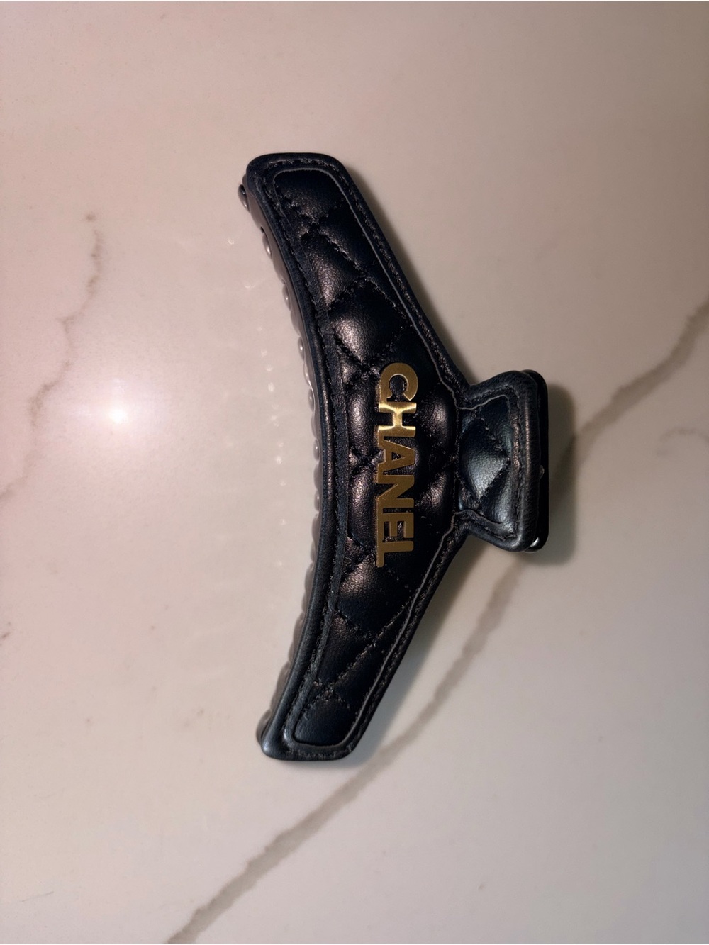 CHANEL Black Quilted Leather Hair Barrette with Gold Logo Accent